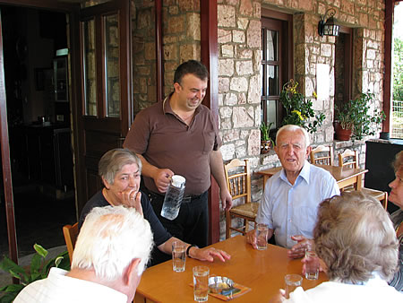Sakis serves a group of fellow travellers who came for their morning coffee